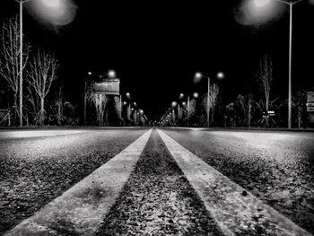 Surface level of road against illuminated city at night