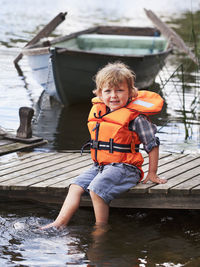 Portrait of boy sitting in boat