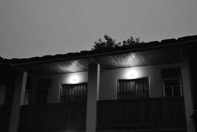 Illuminated building against clear sky at night