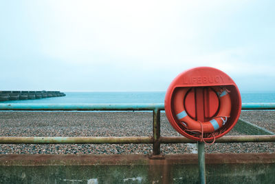Close-up of railing against sea against clear sky
