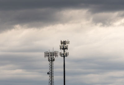 Low angle view of communications tower against sky