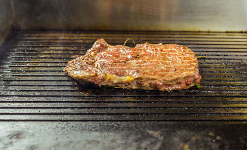 High angle view of meat on barbecue grill