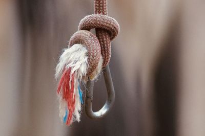 Close-up of rope tied up on hook