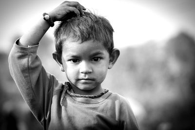 Portrait of boy with hand in hair