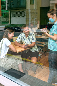 Waiter taking order of man and woman