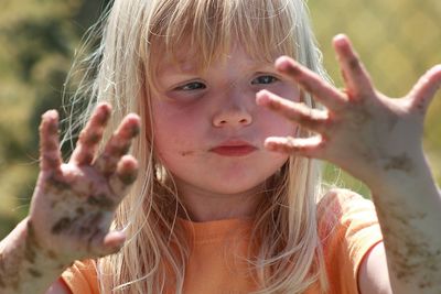 Close-up of girl with dirty hands