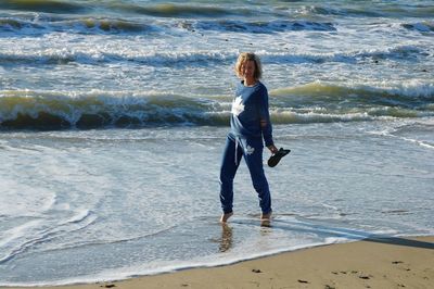 Full length of man standing on beach