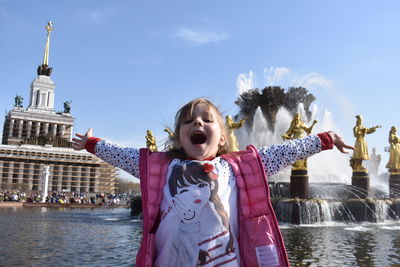 Girl standing by fountain