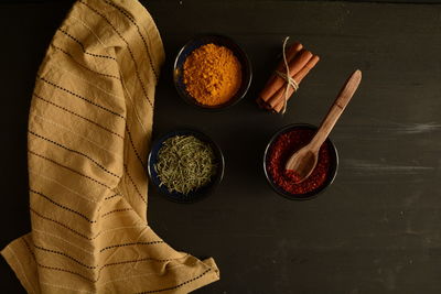 Directly above shot of herbs and spices by fabric on table