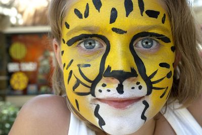 Close-up portrait of smiling girl with face paint