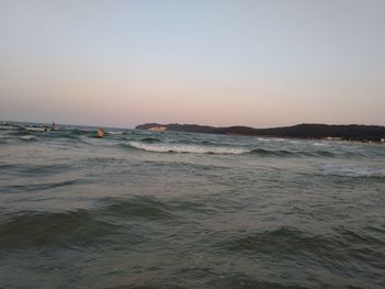 Scenic view of sea against clear sky during sunset