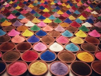 Full frame shot of colorful powder paints in containers