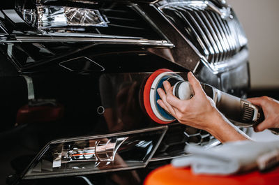 Midsection of man repairing car