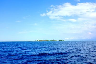 Scenic view of sea against blue sky