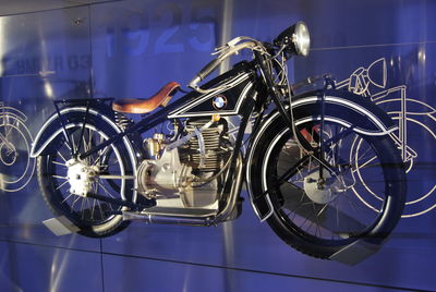 Close-up of bicycle parked against wall