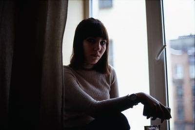 Portrait of woman by window