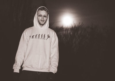 Portrait of young man standing on land against sky