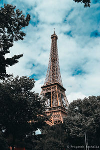 Low angle view of tower against cloudy sky