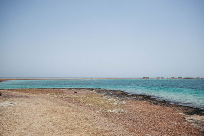 Scenic view of beach against clear sky