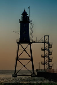 Low angle view of leuchtturm obereversand during sunset