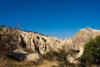 Scenic view of rocky mountains against clear blue sky