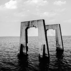 Lifeguard hut in sea against sky