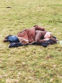 Cat relaxing on grassy field