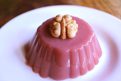 Plate of pelamushi topped with walnut, a popular georgian dessert made with grape juice