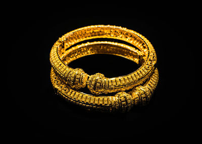 Close-up of metallic structure against black background