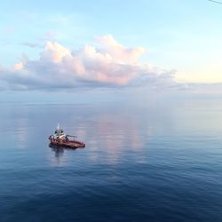 Boat sailing on sea against sky