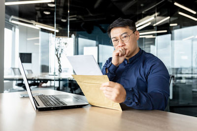 Young man using laptop at table