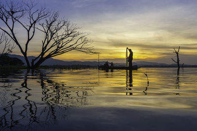 Scenic view of lake against sky during sunset