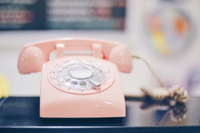 Close-up of telephone booth on table