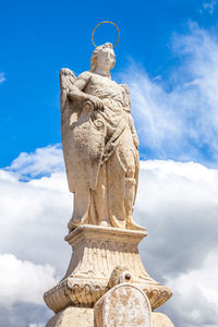 Low angle view of statue against sky