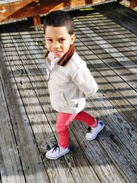 Portrait of happy boy walking on deck