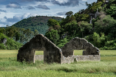 Built structure on field against sky