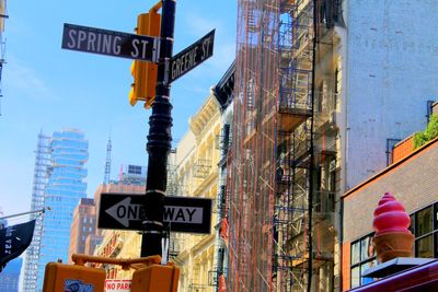 Directional sign by buildings in city