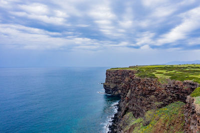 Scenic view of rocks on beach against sky