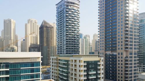 Low angle view of buildings in city against sky