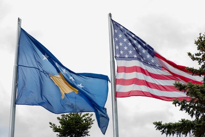 Low angle view of flags against the sky