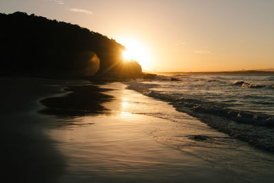 Sunset at high tide on a secluded beach in australia