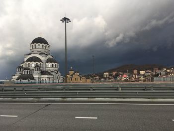 View of city street and buildings against sky