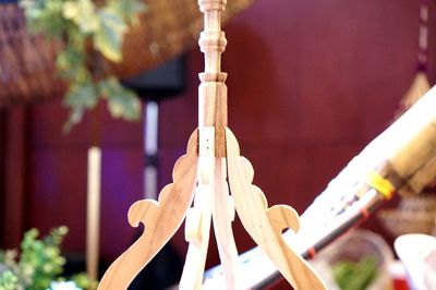 Close-up of cross hanging on wood