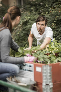 Friends gardening together outdoors