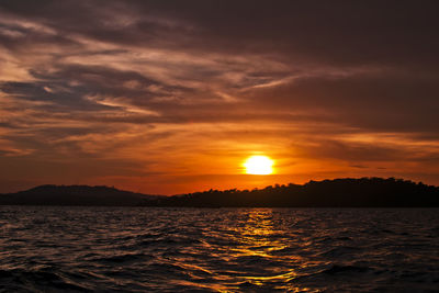 Scenic view of sea against romantic sky at sunset