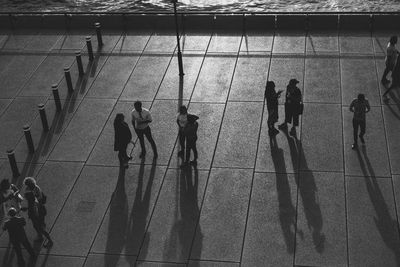 High angle view of people walking on tiled floor