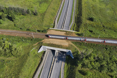 Aerial view of passenger train passing across railroad overpass