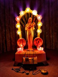 Close-up of illuminated candles on table