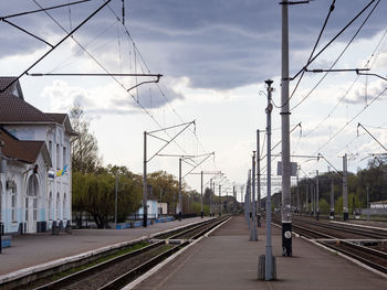 Railroad tracks in city against sky