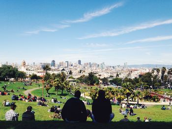 People at park against cloudy sky